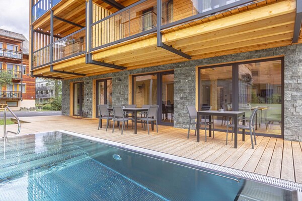 Appartement met privé-spa, sauna & verwarmd zwembad op 240m van de skilift - thumbnail 1