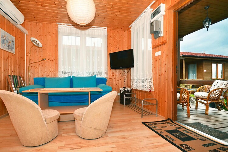 Ground floor: (open kitchen(hob(2 ring stoves, electric), electric kettle, coffee machine, fridge-freezer), Living/bed room(double sofa bed, TV(german television channels), dining table(4 persons)), bedroom(double bed), bedroom(double bed), bathroom(shower, washbasin, toilet))\n\nReception, Internet access, Restaurant, Bar, Bar, Breakfast room, Lawn, baby bath, cot, washing machine(shared with other guests, paid), heating(electric), terrace(roofed), garden(shared with other guests, fenced, 1500 m2), garden furniture, sun loungers, BBQ(charcoal), parking, trampoline(shared with other guests), slide(shared with other guests), high chair, toys, Swing set