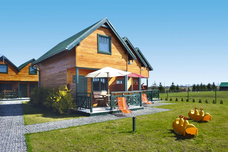 There is a family holiday center in a quiet part of the resort. There are two-story terraced houses waiting here, each with a covered terrace. Just 350 m from the beach. Sarbinowo is a quiet place on the Baltic Sea, 30 km from KoÅ‚obrzeg and 7 km from Mielno.
A cozy, comfortable wooden house with a terrace. On the ground floor there is a spacious living room with a kitchenette and a bathroom with a shower. The living room has a table with chairs, TV and a 2-seater sofa. There are 2 separate bedrooms on the first floor. One of them has a balcony. Electric heating. There is a set of garden furniture on the terrace. Barbecue facilities are available. There is wireless internet.
There is a playground for the youngest guests. There is a parking lot, an outdoor gym and a beach volleyball court on the fenced property.
The price of the stay includes: bed linen, water consumption, parking, internet, final cleaning.
Sarbinowo is a small, picturesque summer resort on the west coast, a few kilometers west of Mielno. There are clean, wide beaches here, perfect for escaping the hustle and bustle of the city. It is a perfect place for a trip with family or friends.
In the immediate vicinity it is worth visiting the Museum of the Fishing Village in ChÅ‚opy.
For families with children, the Pomerania Fun Park amusement park will be a perfect destination for a full-day trip. On an area of over 30 hectares, the whole family can spend time having fun together. Additionally, guests have at their disposal two restaurants and numerous food outlets.
Not far from the center there is the international bicycle route R-10, stretching around the Baltic Sea basin. We recommend trips to the picturesque ChÅ‚opy, the center of Sarbinowo, the lighthouse in GÄ…ski, and Ustronie Morskie.