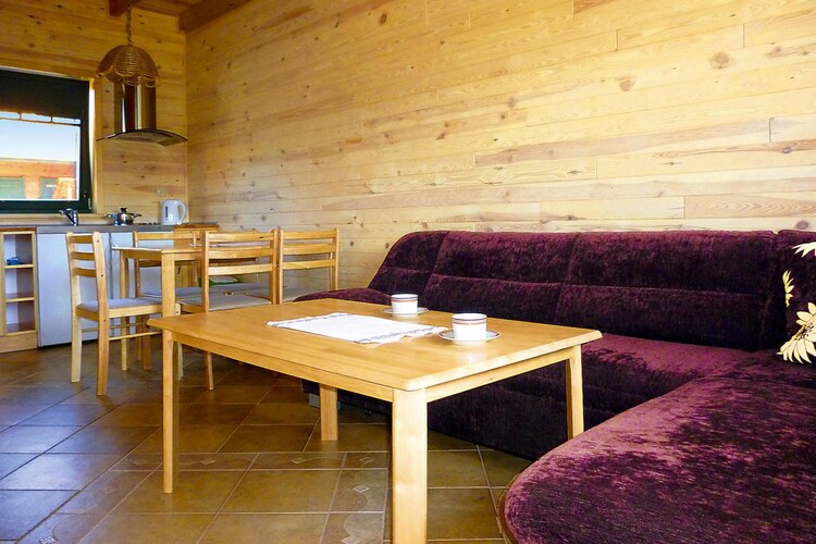 Ground floor: (open kitchen(hob(2 ring stoves, ceramic, electric), electric kettle, microwave, fridge-freezer), Living/diningroom(25 m2)(double sofa bed, TV(flatscreen, satellite, german television channels), dining table), bathroom(shower, washbasin, toilet))\n\nOn the 1st floor: (bedroom(single bed, double bed), bedroom(single bed, double bed))\n\nReception, Internet access, Play area, Lawn, balcony, heating(electric), terrace(roofed), garden(shared with other guests, fenced, 2700 m2), garden furniture, sun loungers, BBQ(charcoal), parking, trampoline(shared with other guests), sand pit(shared with other guests), play equipment(shared with other guests), slide(shared with other guests), fitness equipment(shared with other guests), Sunscreen, Volleyball court, Swing set