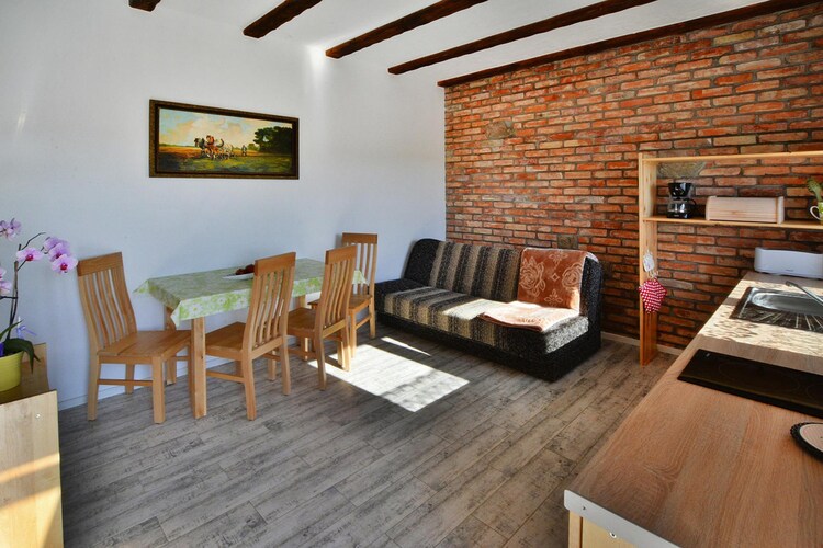 A holiday resort on a fenced and safe area in a quiet summer settlement, focused on providing excellent relaxation for families with children. The seaside beach is about a 20-minute walk away. You can also get to the sea by bike (rental on site). The area around the resort is an oasis of peace and quiet.
A cozy, 2-room apartment provides comfortable accommodation and access to the entire infrastructure of the resort. The apartment on the ground floor consists of a living room combined with a well-equipped kitchen, a bedroom with a double bed and a bathroom with a shower. The living room has a fold-out double sofa, a table and TV. In front of the entrance there is a private garden, where a set of garden furniture and barbecue equipment await. Central heating. Wireless Internet is available.
A washing machine is available to all guests of the resort (for a fee). On the fenced and well-kept area there is a recreational shelter, where there is a table tennis table and table football. There is also a volleyball court and a bike rental. The youngest will certainly be delighted by the safe and attractive playground.
The price of the stay includes: bedding, electricity and water consumption, internet, parking, final cleaning.
Rusinowo is a quiet, small summer resort located on the central coast, close to DarÅ‚owo, JarosÅ‚awiec and Ustka. Wonderful climate and landscapes, pine forests, clean water in the sea - these are the advantages of Rusinowo. The settlement has retained its intimate atmosphere, even in the peak season there are no crowds on the beach.
Jaroslawiec, which is neighboring Rusinowo, offers many interesting attractions that will diversify your seaside vacation. JarosÅ‚awiec also offers a rich gastronomic base. There is a high seaside cliff, from where there is a unique, panoramic view of the sea. There is a marina for fishing boats, a swimming pool complex Panorama Morska (open all year round).