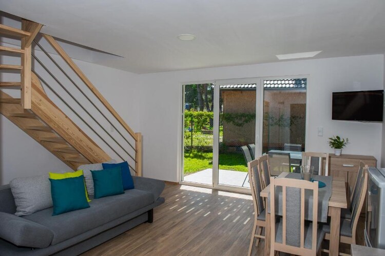 Ground floor: (open kitchen(electric kettle, cooker(4 ring stoves, gas), hood, microwave, fridge-freezer), Living/diningroom(double sofa bed, TV(flatscreen), dining table), bathroom(shower, washbasin, toilet))\n\nOn the 1st floor: (bedroom(double bed(160 x 200 cm)), bedroom(single bed, single bed, single bed))\n\nReception, Internet access, Bike rental, Play area, Lawn, cot, balcony, heating(electric), terrace(roofed), garden(shared with other guests, fenced, 3000 m2), garden furniture, BBQ(charcoal), parking, trampoline(shared with other guests), swimming pool(shared with other guests, outside, heatable, cover, 11 x 4 m., opened from 1/2 May upto and including Sep), sand pit(shared with other guests), slide(shared with other guests), high chair, Volleyball court, Swing set