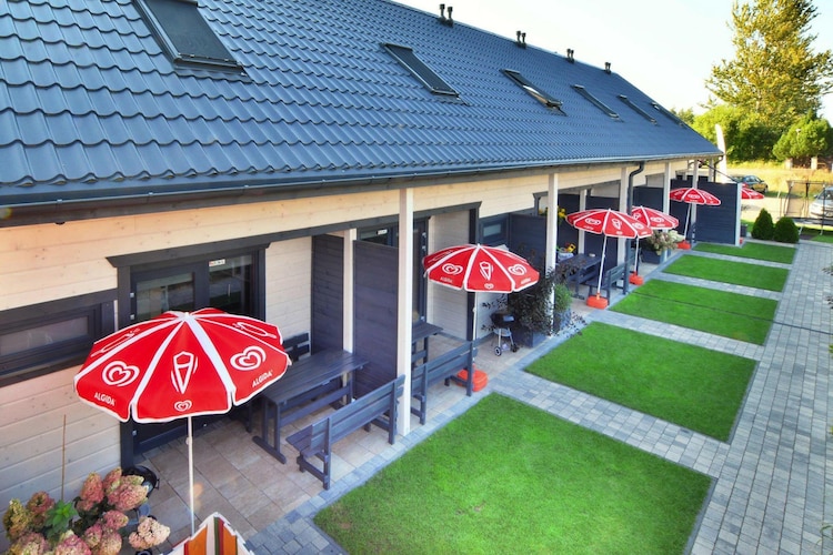 A family-friendly holiday resort in a very quiet area, 200 meters from the beach. Just a few steps from the resort center.

Comfortable, two-story holiday homes with covered terraces. On the ground floor, there's a living room (TV, dining table, double sofa bed), a fully equipped kitchen, and a bathroom with a shower (including a washing machine). On the first floor, there are two triple bedrooms. The terrace is equipped with garden furniture and barbecue facilities. Electric heating is available. Wireless internet is available.

The well-maintained and fenced grounds include an attractive playground and a well-equipped playroom. Bicycle rentals, table tennis, and table football are available. A sauna and jacuzzi are available for an additional fee. Secure parking is available (one space per cottage included in the price; an additional parking space is available at an additional cost).

The price includes: bed linen, internet, and parking (one space per cottage). A cot and highchair are available upon request (reservation required). SianoÅ¼Ä™ty is a small holiday village located approximately 10 km from KoÅ‚obrzeg, in the immediate vicinity of another seaside resort, Ustronie Morskie. SianoÅ¼Ä™ty is situated right next to a wide beach. The golden sand and gentle slope into the sea encourage vacationers to sunbathe and swim. Neighboring Ustronie Morskie also boasts a 100-meter-long pier. The international R-10 cycling trail runs through SianoÅ¼Ä™ty. It runs along the coast and offers stunning views of the beaches, clear sea, and charming peat bogs. From here, cycling is an easy and pleasant way to reach nearby Ustronie Morskie, as well as the larger city of KoÅ‚obrzeg.