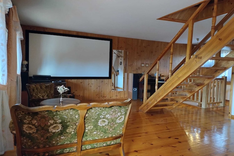 On the 1st floor: (Living room(fireplace, seating area, radio, stereo unit, chromecast), dining room(80 m2)(dining table(12 persons)), Kitchen(electric kettle, toaster, cooker(4 ring stoves, gas), coffee machine, oven, microwave, fridge), bedroom(single bed, single bed), bathroom(shower, washbasin, toilet, hairdryer))\n\nOn the 2nd floor: (bedroom(double bed, balcony), bedroom(single bed, single bed, balcony), bedroom(single bed, single bed), bathroom(shower, washbasin, toilet))\n\nAttic: (bedroom(single bed, single bed, single bed, single bed))\n\nInternet access, Lawn, heating(central), terrace(private, roofed, 50 m2), garden(shared with the owner , fenced, 5000 m2), garden furniture, sun loungers, BBQ(charcoal), parking, pond, hammock, high chair, outdoor fireplace, Swing set, baby crib(free)