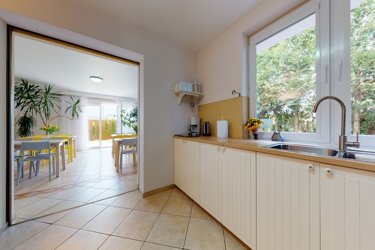 Ground floor: (dining room(TV, dining table), Kitchen(electric kettle, boiling water tap, cooker(4 ring stoves, induction), espresso machine, microwave, dishwasher, fridge-freezer), bedroom(single bed, single bed, TV, electric kettle, fridge), bedroom(single bed, single bed, TV, electric kettle, fridge), bedroom(single bed, single bed, single bed, TV, electric kettle, fridge), bathroom(shower, washbasin, toilet), bathroom(shower, washbasin, toilet), bathroom(shower, washbasin, toilet))\n\nOn the 1st floor: (bedroom(single bed, single bed, TV, electric kettle, fridge), bedroom(single bed, single bed, single bed, TV, electric kettle, fridge), bedroom(single bed, single bed, single bed, TV, electric kettle, fridge), bedroom(single bed, single bed, single bed, TV, electric kettle, fridge), bedroom(single bed, single bed, single bed, TV, electric kettle, fridge), bathroom(shower, washbasin, toilet), bathroom(shower, washbasin, toilet), bathroom(shower, washbasin, toilet), bathroom(shower, washbasin, toilet), bathroom(shower, washbasin, toilet))\n\nOn the 2nd floor: (bedroom(single bed, single bed, TV, electric kettle, fridge), bedroom(single bed, single bed, TV, electric kettle, fridge), bathroom(shower, washbasin, toilet), bathroom(shower, washbasin, toilet))\n\ncamping cot, garden(private, fenced, landscaped garden, 1000 m2), garden furniture, BBQ, parking, play equipment