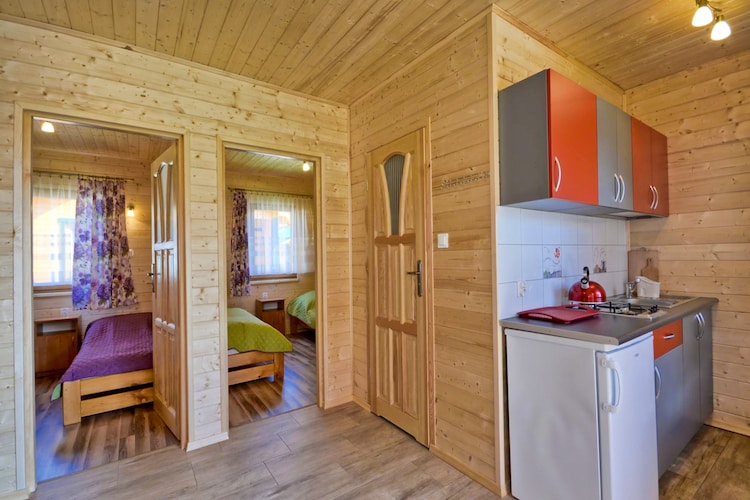 Ground floor: (open kitchen(hob(2 ring stoves, induction), electric kettle, toaster, fridge-freezer), Living/diningroom(double sofa bed, TV(flatscreen), dining table), bedroom(single bed, double bed), bedroom(double bed or 2 single beds), bathroom(shower, washbasin, toilet))\n\nReception, Internet access, Parking, Play area, Lawn, terrace, garden(shared with other guests, fenced, 2000 m2), garden furniture, sun loungers, BBQ(charcoal), trampoline, sand pit, slide, ironing board, iron, Swing set