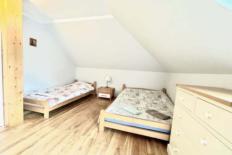 We offer a comfortable 3-person room with a private bathroom in a holiday home in Ruciane Nida. A shared kitchen with a dining area is available to all guests. Parking, internet access, and satellite TV are provided.

A beautiful garden surrounds the house, perfect for relaxing outdoors. Garden furniture, a barbecue, and a children's playground are available, making this an ideal place for both couples and families with children.

A relaxing sauna and jacuzzi are available for those interested, available for an additional fee of PLN 50 per hour per person.

Masuria is the perfect place to relax for nature lovers and water enthusiasts. Our comfortable accommodations in Ruciane Nida are located close to the picturesque Pisz Forest – one of the largest forest complexes in Poland, perfect for hiking, cycling, and communing with nature.

Furthermore, our holiday home is located near a marina, making us a great base for exploring the delights of the Great Masurian Lakes Trail. This unique place allows for sailing, fishing, or simply relaxing by the water.