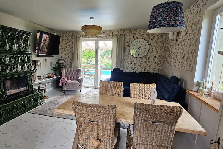 Kielno is a small and incredibly picturesque town, only a 30-minute drive from Gdańsk. It is located near two beautiful Kashubian lakes – Kielno and Wysoka.
A comfortable holiday home with a private, exceptionally well-kept garden. The house is two stories high. On the ground floor, there's a spacious, atmospheric living room (satellite TV with Netflix, a double sofa bed, and a dining table), a well-equipped kitchen, a bathroom with a shower, and a laundry room. On the first floor, there are four double bedrooms (two of which have TVs) and a bathroom with a bathtub. There's a library and board games. The house has a large, covered terrace with garden furniture, a swing, and a gas grill. Central heating and wireless internet are available.
In front of the house, on the terrace side, is a heated swimming pool surrounded by loungers and inflatable armchairs. The garden surrounding the house is home to several fruit trees, as well as strawberries, blueberries, currants, blackberries, wild strawberries, peaches, and a vegetable garden. Hazelnuts and walnut trees complete the landscape. A bonfire is available in the garden. Three parking spaces are available within the fenced area. Two complimentary bicycles are available for guests' use.
The price includes: bed linen, towels, electricity, water, heating, swimming pool, parking, internet, final cleaning, and resort tax.
The immediate vicinity of the house is filled with endless meadows and forests, with numerous hiking and cycling trails. Within a 3-4 km radius, there are several lakes with beautiful shorelines, beaches, and water sports equipment rentals. The Tricity area and numerous seaside beaches in Gdynia, Gdańsk, and Sopot are just 20-25 km away.